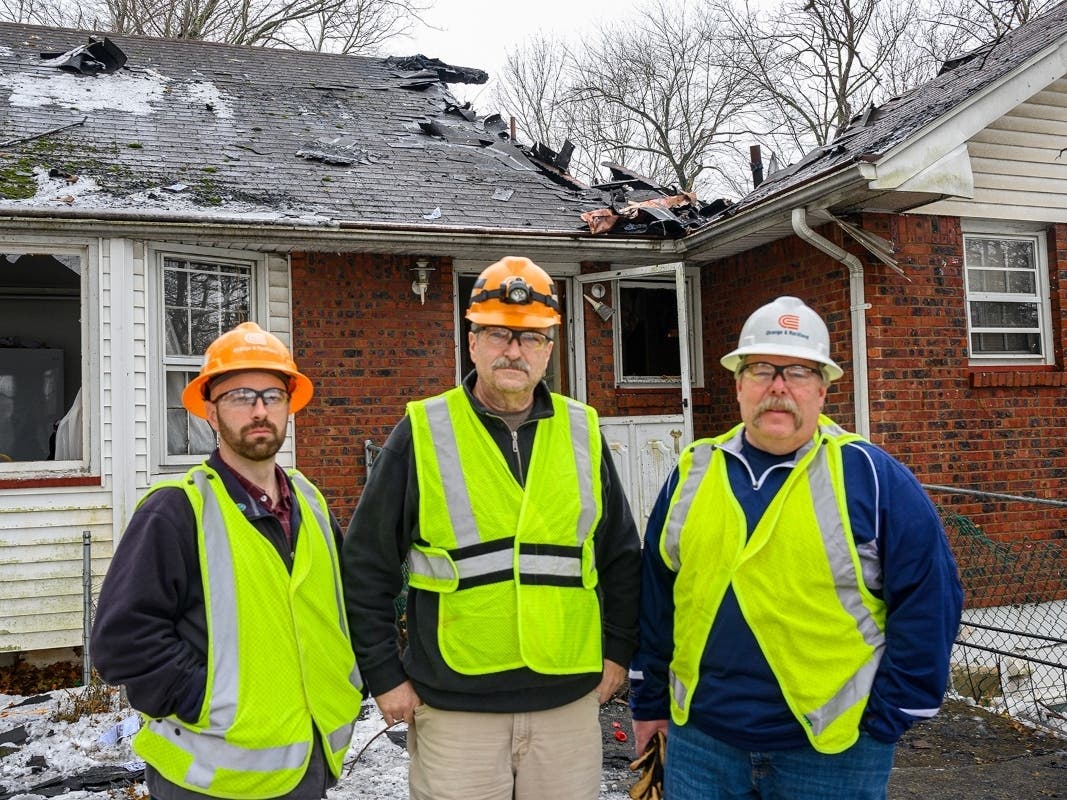 O&R employees James Lynch, Ross Dailey and Ted Ryder at the scene of yesterday’s house fire in Monsey where Ryder and Lynch rescued an elderly man from the burning building.