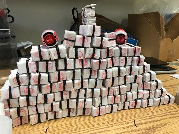 The brand stamp on the drug ring's packaging was a red smiley face logo.