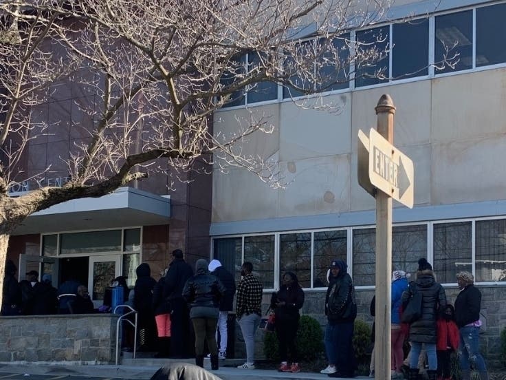 Parents stood in line to pick up computers for their kids as the Mount Vernon school district pivoted into distance learning because of the new coronavirus outbreak. 
