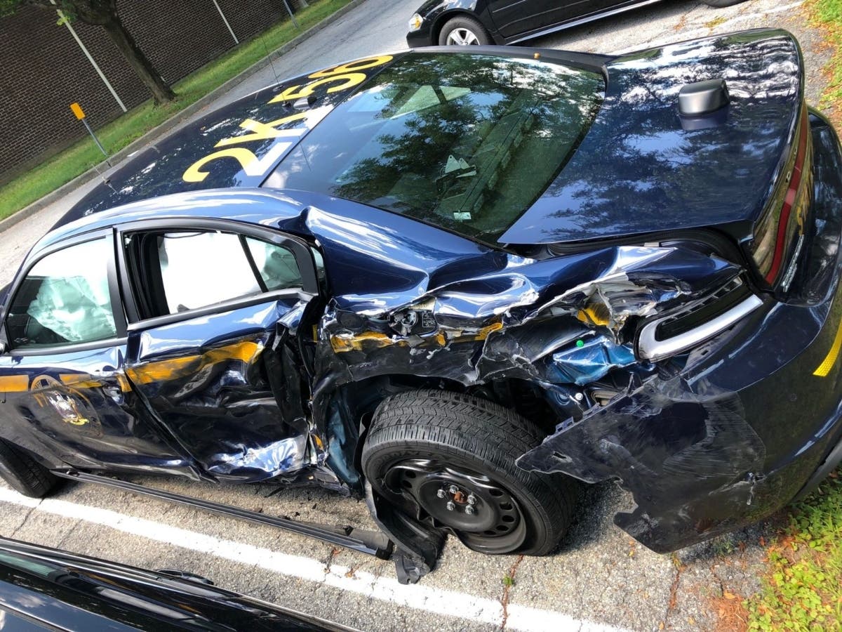 New York State​ police are looking for a tractor-trailer that injured a trooper and smashed a police car on I-84 Friday.