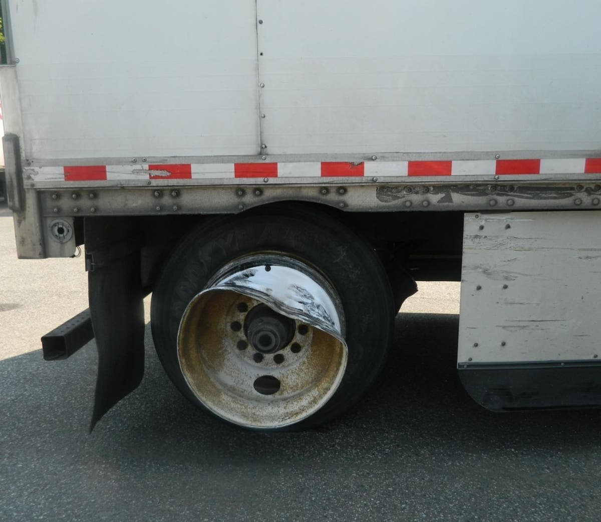 New York state police show damage to a tractor-trailer alleged to have done major damage to a police car.