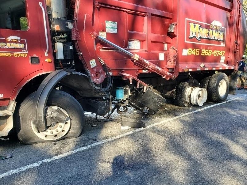 A collision between a garbage truck and an SUV injured four and closed Route 303 for hours Oct. 1.