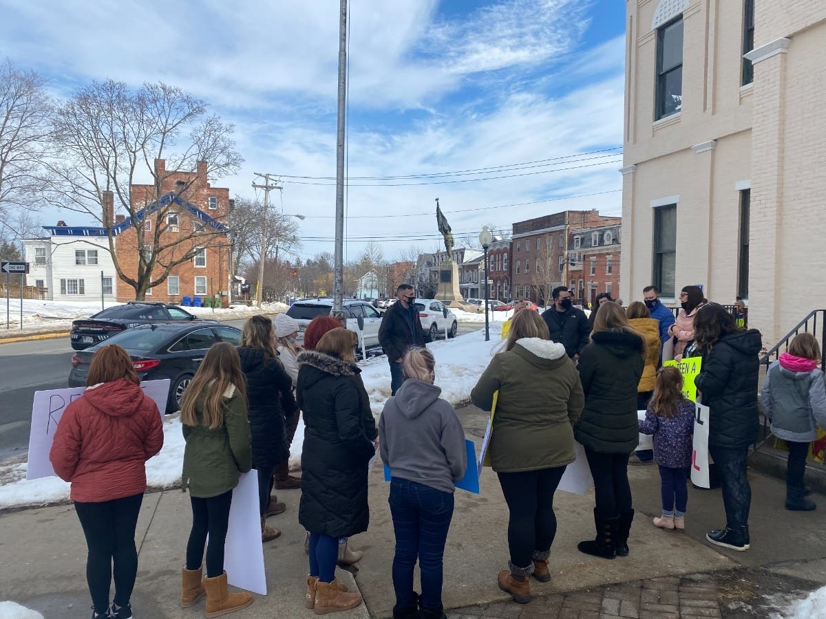 Parents rallied in Goshen Feb. 24 calling for schools to fully reopen for in-person learning.