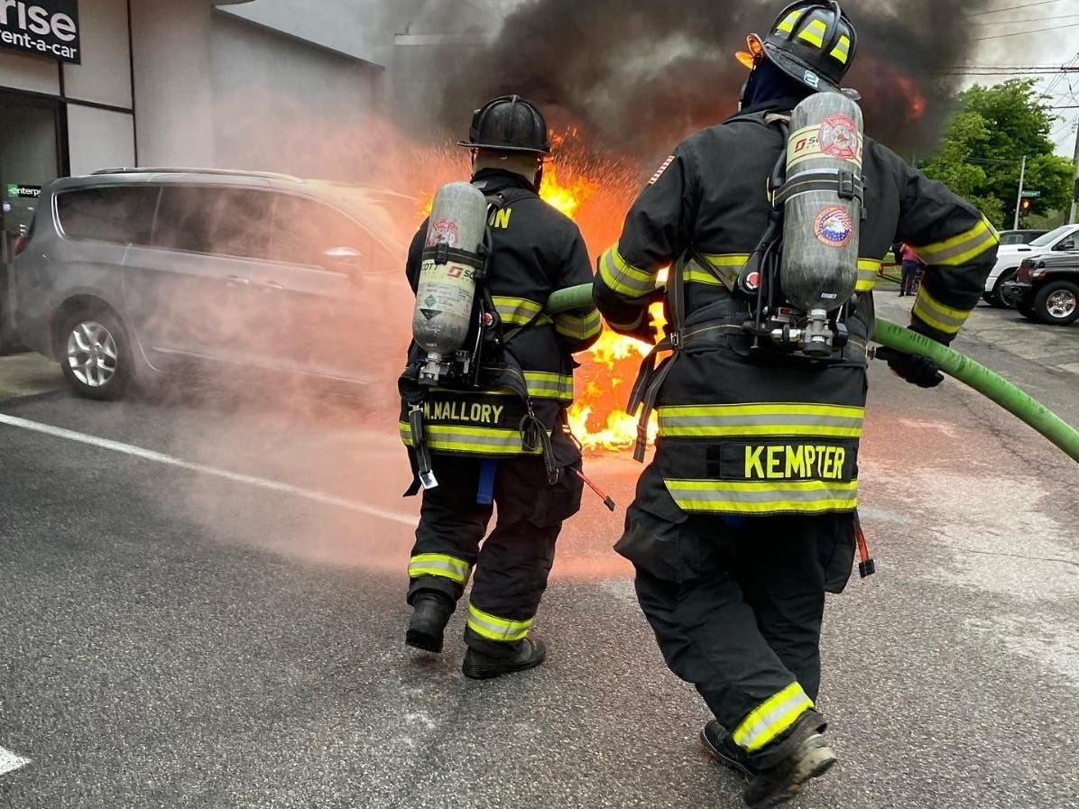 Firefighters controlled a car fire, keeping it from spreading to the auto dealership building.