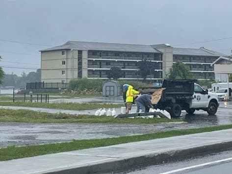 Crews pile sandbags at a culvert next to Route 6 in Putnam County.