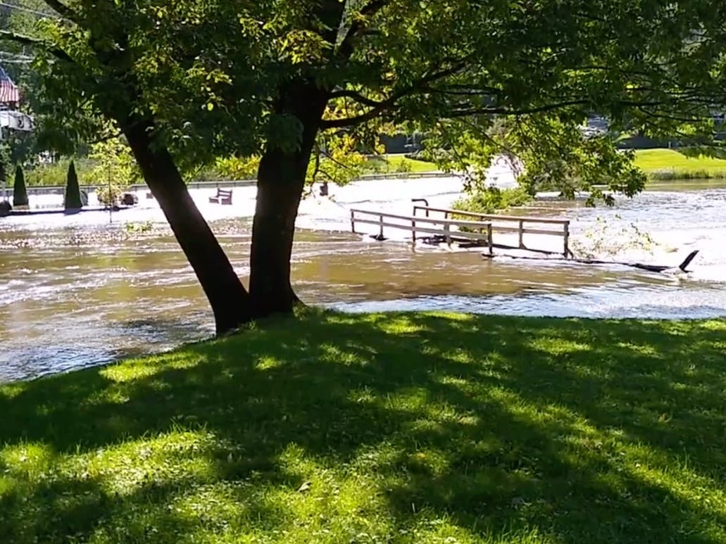 The pedestrian bridge at Lake Carmel was awash Thursday morning as flood runoff continued from post-tropical cyclone Ida.