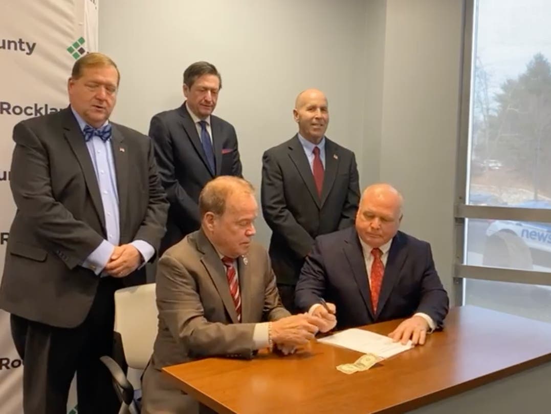 Rockland officials exchanged a two-year contract and a dollar bill as animal control enters a new phase in the county.