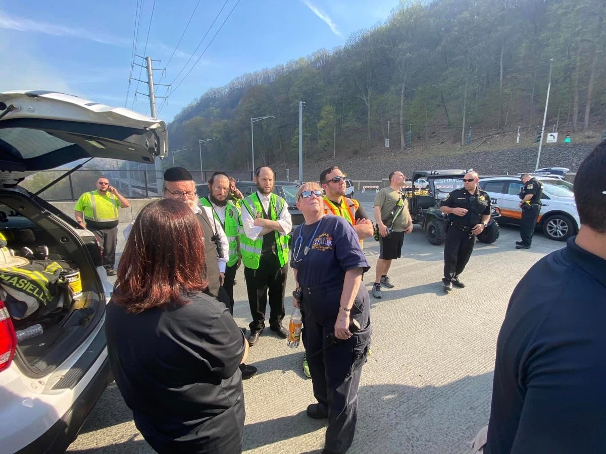 County and local emergency responders and officials watched helicopters over brush fires along the railroad tracks in northern Rockland County Friday.