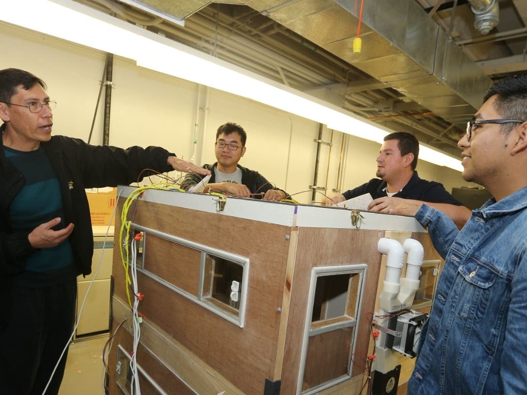 Cal State LA Professor Arturo Pacheco-Vega, left, instructing students in his mechanical engineering class. 