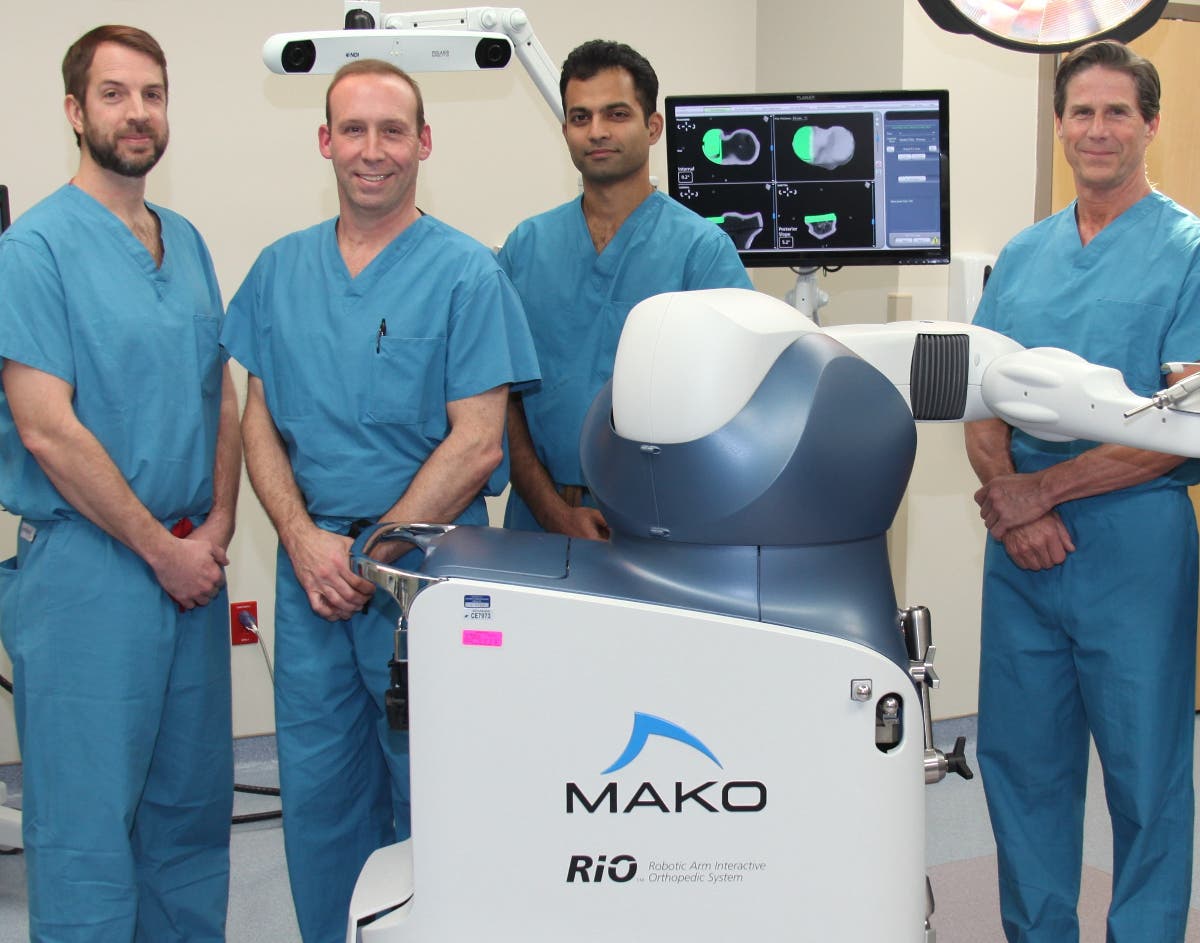 University of Maryland Upper Chesapeake Health joint surgeons Mark Clough, M.D., Edward O’Mara, M.D., Raj Yalamanchili, M.D, and William Cook, M.D., are with  a MAKO Rio, an interactive robotic arm used for computer assisted joint replacement makoplasty.