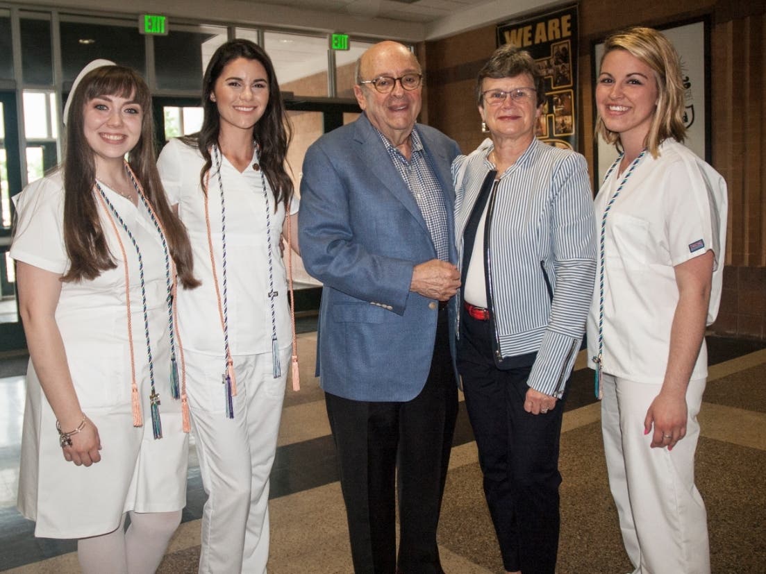 Dr. David and Alena Schwaber join nursing students Julia Akehurst, Katelyn Dietz and Katie Szabo at the May 2018 nursing pinning ceremony at Harford Community College. 