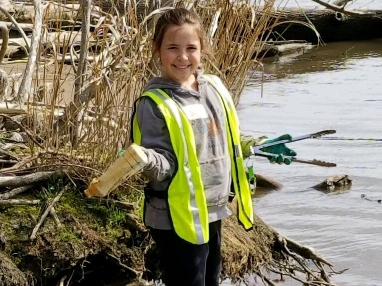 Conowingo Elementary Enviro-Club member Danika Coleman removes debris on Garrett Island during the 2018 River Sweep. 