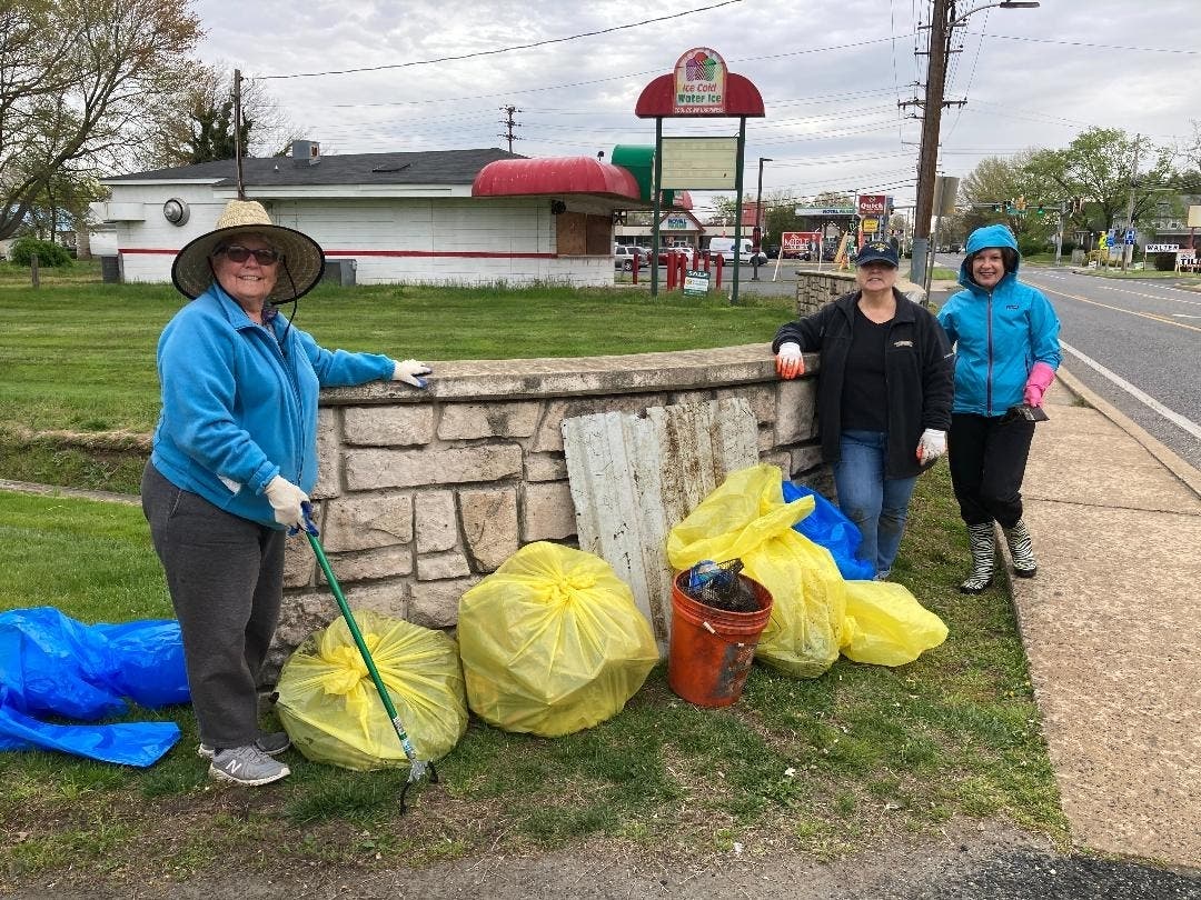 Jane Machin, Donna Nichols and Debbie McKeown, members of the Harbor of Grace Chapter of the Daughters of the American Revolution, collect trash and debris on Revolution Street in Havre de Grace during River Sweep on April 23. 