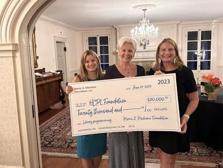 Carolyn Lambdin, president of The Morris A. Mechanic Foundation (center), presents a $20,000 donation to the Harford County Public Library Foundation to the Library’s Amber Shrodes (left) and Mary Hastler. 