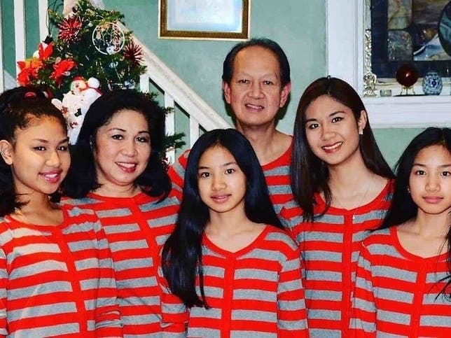 Audie Marquez Trinidad, 61, center, and wife Mary Rose Ballocanag, second from left, and their daughters.