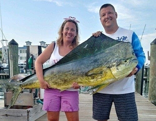 Kristi Frashure poses with her husband, Ryan, and the record fish she caught off Ocean City. 