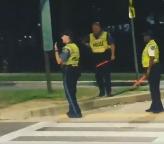 A Howard County police officer busts out his salsa dancing moves while monitoring a crosswalk in Columbia near the Merriweather Post Pavilion. 