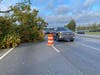 Vehicles maneuvered around a fallen tree on U.S. 78 in Snellville Thursday. Emergency responders and public works crews around the Atlanta region responded to calls for downed trees on power lines, homes and cars as Tropical Storm Zeta hit the area.