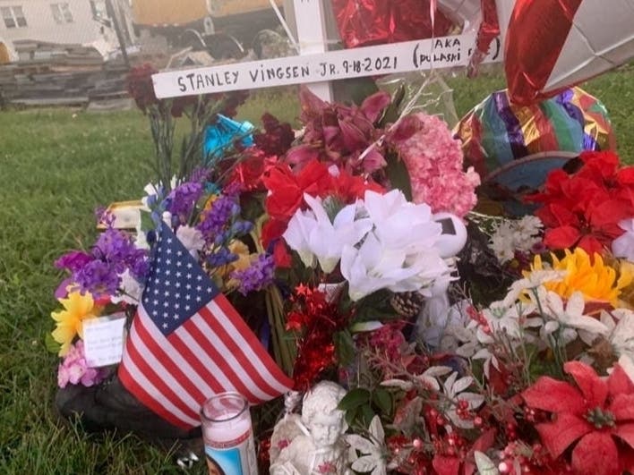 A memorial honoring the "Walking Man" was set up after he died in a crash. Candles line Pulaski Highway on either side of the growing collection of flowers and balloons.