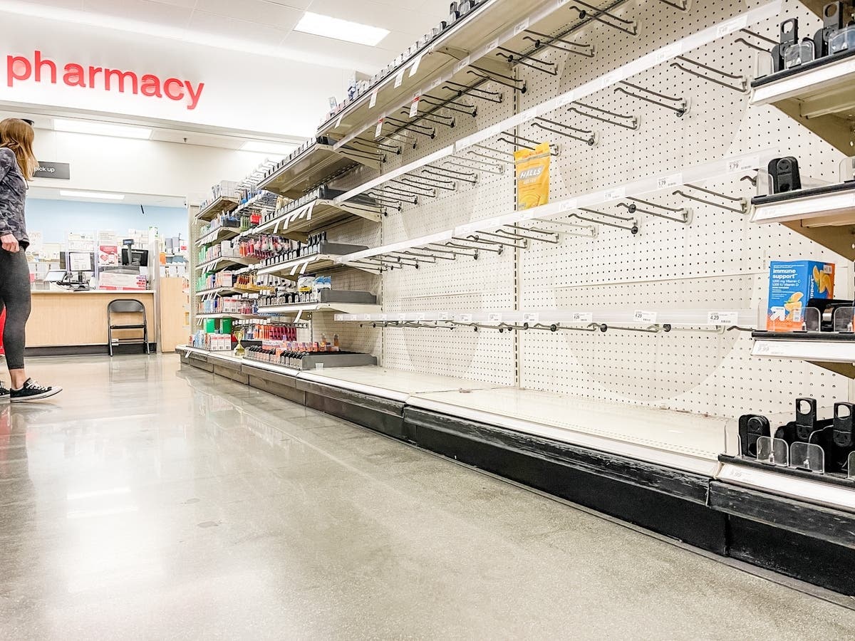 A shopper looks for items on empty shelves at a Target store on Jan. 1. Consumer prices jumped 7.5 percent last month compared with a year earlier, the steepest since February 1982, federal officials said.