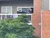 Detectives install equipment on the balcony of a second floor apartment. Three bodies were found in an apartment in the 4200 block of Mazarin Place in Fairfax.