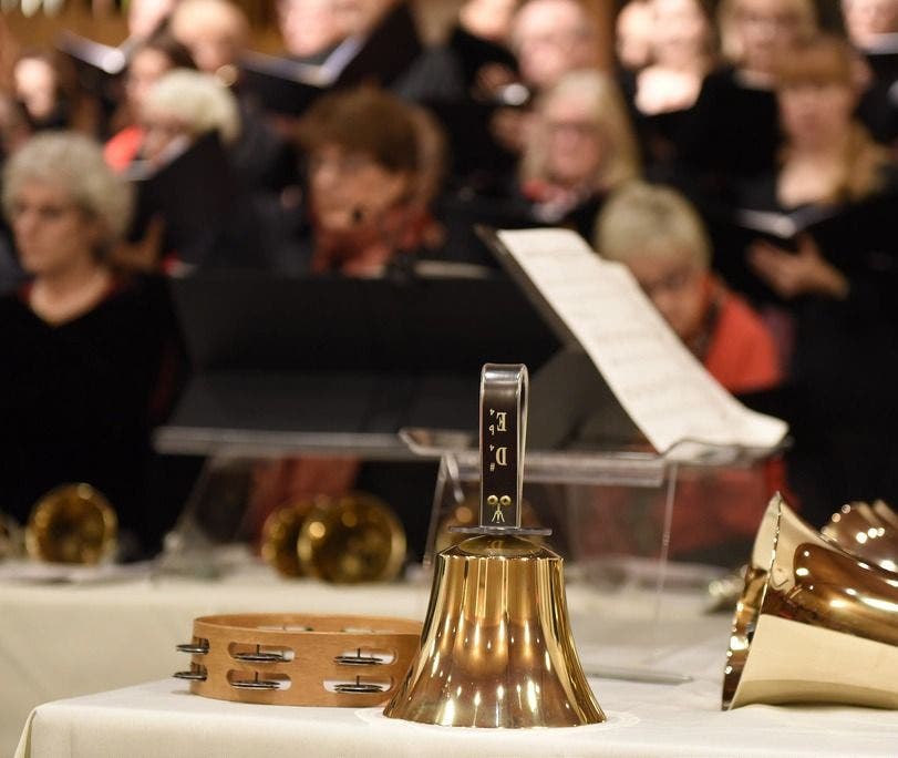 https://patch.com/img/cdn20/users/7162/20161130/112236/styles/raw/public/article_images/christmas_2015_foreground_bells_with_blurred_singerslarge_1x_cropped-1480521834-6973.jpg