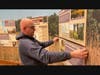 Curator Dan Bartlett installs panels in the "People of the Prairie" exhibit.