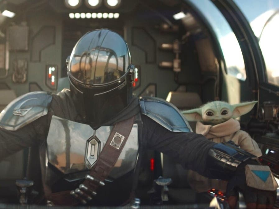 Grogu and Din Djarin / The Mandalorian (Pedro Pascal) in Lucasfilm's "The Mandalorian and Grogu."