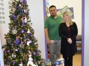 Photo Caption (L-R): Versiti Blood Center of Illinois employees Alan Garcia and Kathy Stevry at the Treasure Chest Foundation facility, proudly display the donated toys which will help comfort young cancer patients.