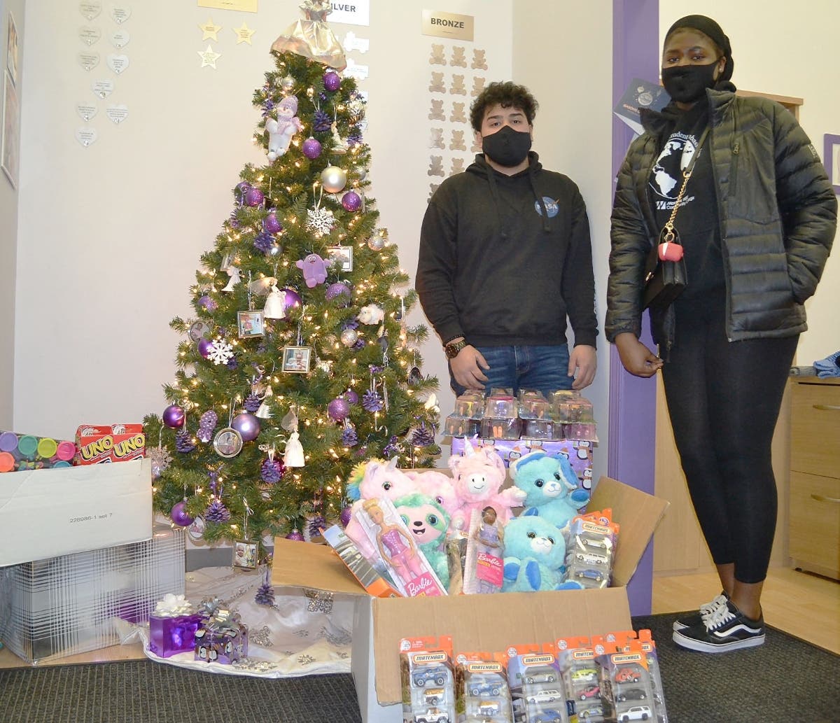 (l-r) International Student Ambassadors from Moraine Valley Community College Damien Moreno (Mexican American) and Chinenye Ebisi (Nigeria) display the items collected for children fighting cancer at the Treasure Chest Foundation warehouse in Orland Park.