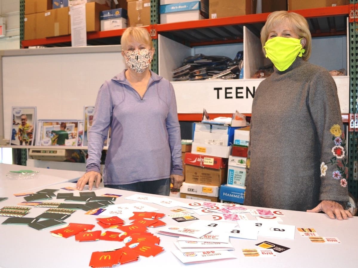 (L-R): South Suburban Bunco Babes Club members Nancy Miller and Janet Loughrey display their donation of $365 in gift cards in increments of $5.00 at the Treasure Chest Foundation’s Orland Park facility. 