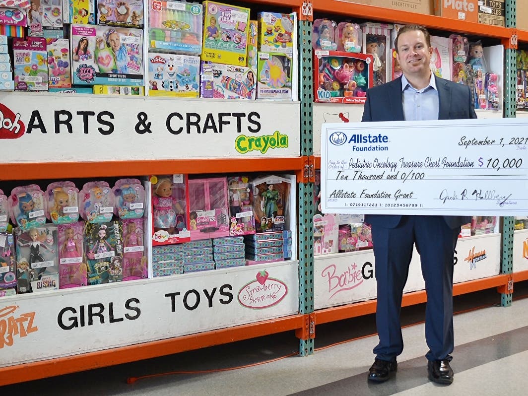 Allstate Agency Owner and grant organizer Jack R. Hallberg proudly presents the $10,000 donation while visiting at the Pediatric Oncology Treasure Chest Foundation’s Orland Park facility. 