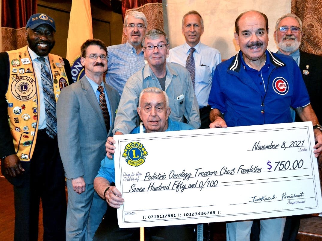 Members of the Beverly Ridge Lions Club present the Lion’s Club $750 donation to the Treasure Chest Foundation during their weekly meeting at 115 Bourbon Street in Merrionette Park. 

