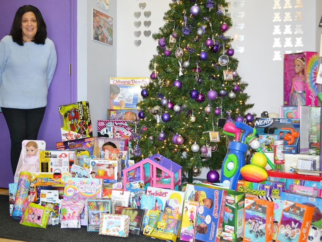 Assumption Greek Orthodox Church parishioner Dorothy Michalarias displays some of the toys collected during the church’s holiday toy drive at the Treasure Chest Foundation’s Orland Park warehouse.