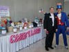 Former Treasure Chest Foundation Board President R. Jack Hallberg (left) poses with a donor next to a sea of raffle prizes.