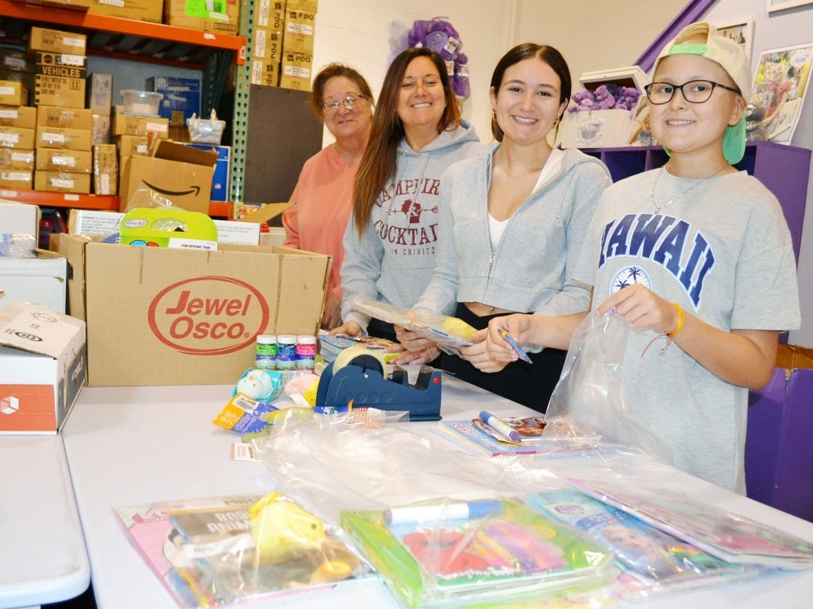Members of the Domark and Glas family representing three generations including (pictured left to right) Kathy Domark (grandmother), Danielle Glas, Jenna Glas (age 16) and childhood cancer patient Olivia Glas (age 13) among some of the gift bags created.