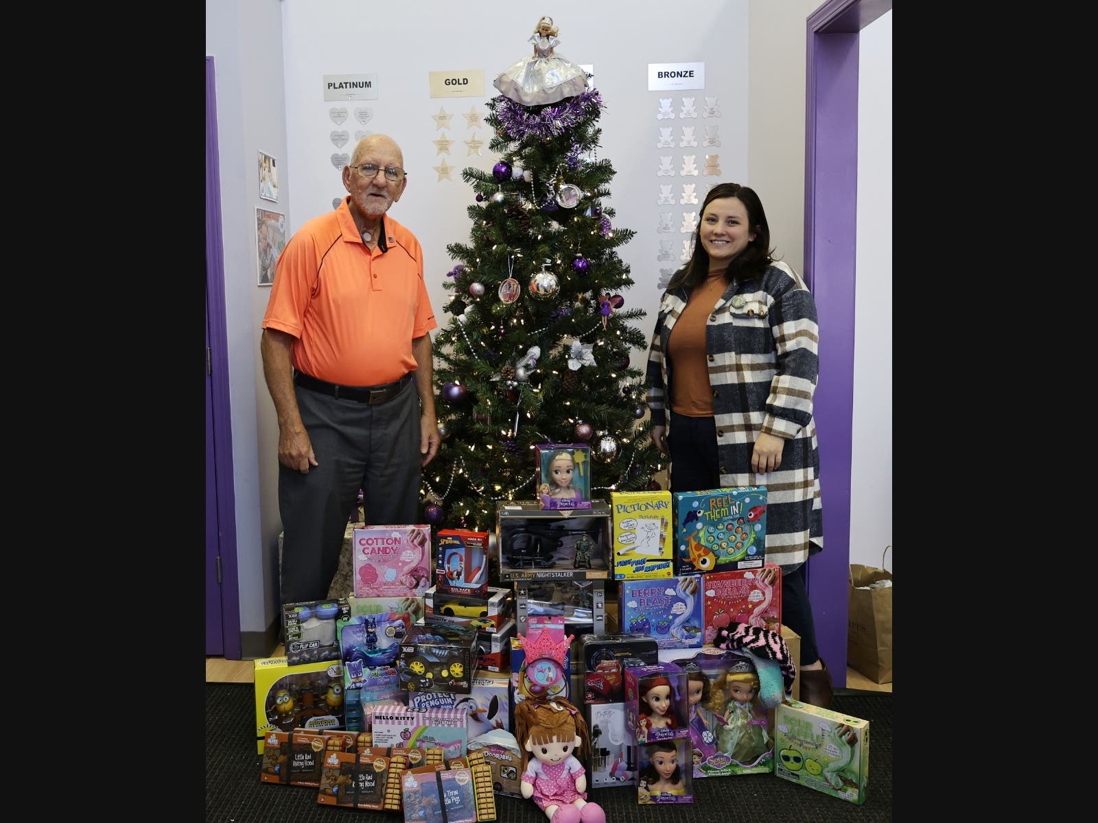 VFW Post 2791 Veteran Roger Barton and Executive Director Kendra Connor display the holiday toy drive donation at the Treasure Chest Foundation’s Orland Park warehouse. The donations will be distributed to Children's Cancer Treatment Centers.