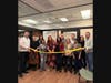 Furniture and design reps, Westfield Library Board of Trustee members, Board President Michelle Habayeb (with scissors), and Library Director Allen McGinley (far right) celebrate the completion of seven new study rooms.