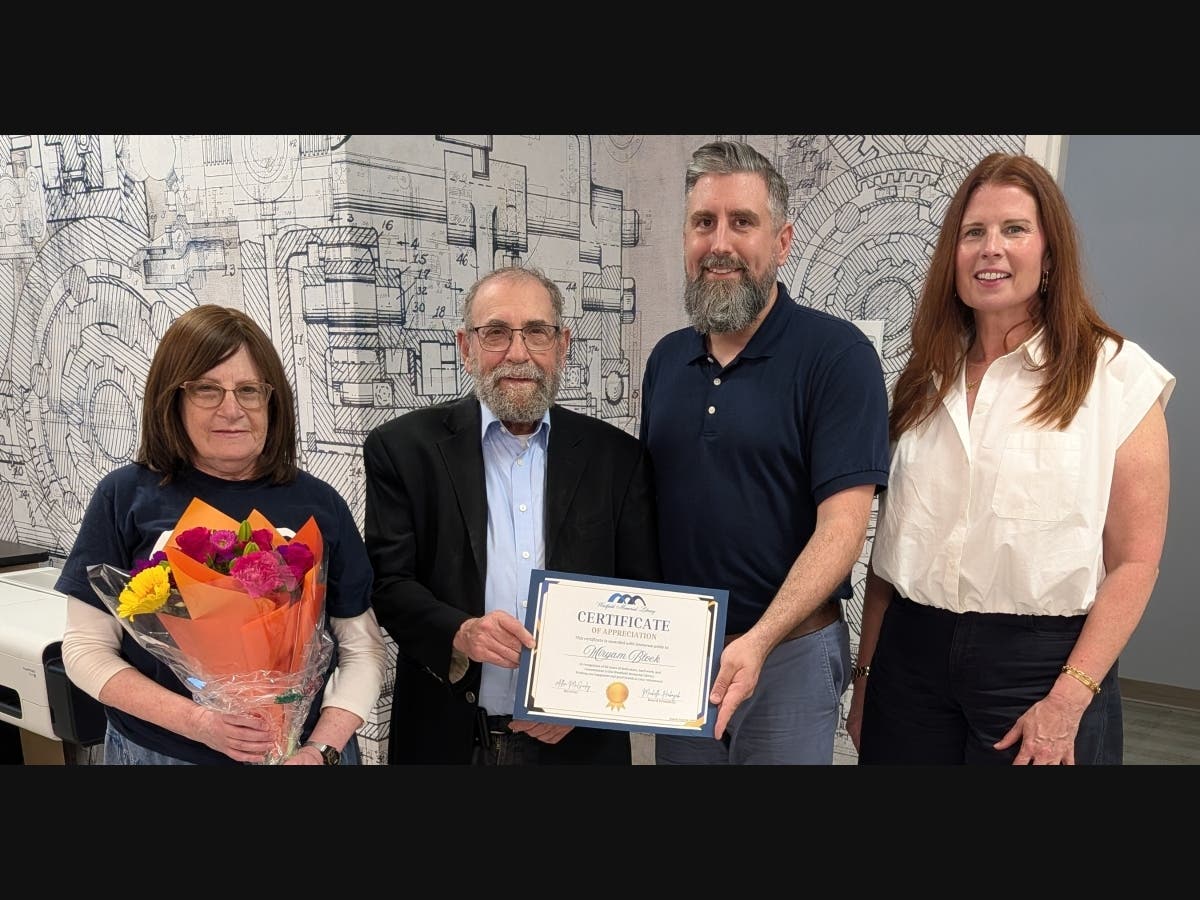 Left to Right, Miryam Block, her husband, library Director Allen McGinley and Library Board of Trustees President Michelle Habayeb.