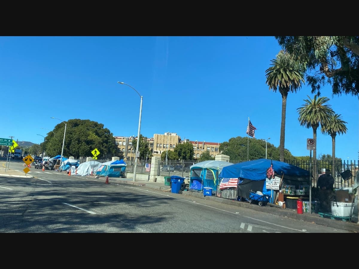 A homeless encampment has taken over the sidewalk along San Vincente Boulevard.