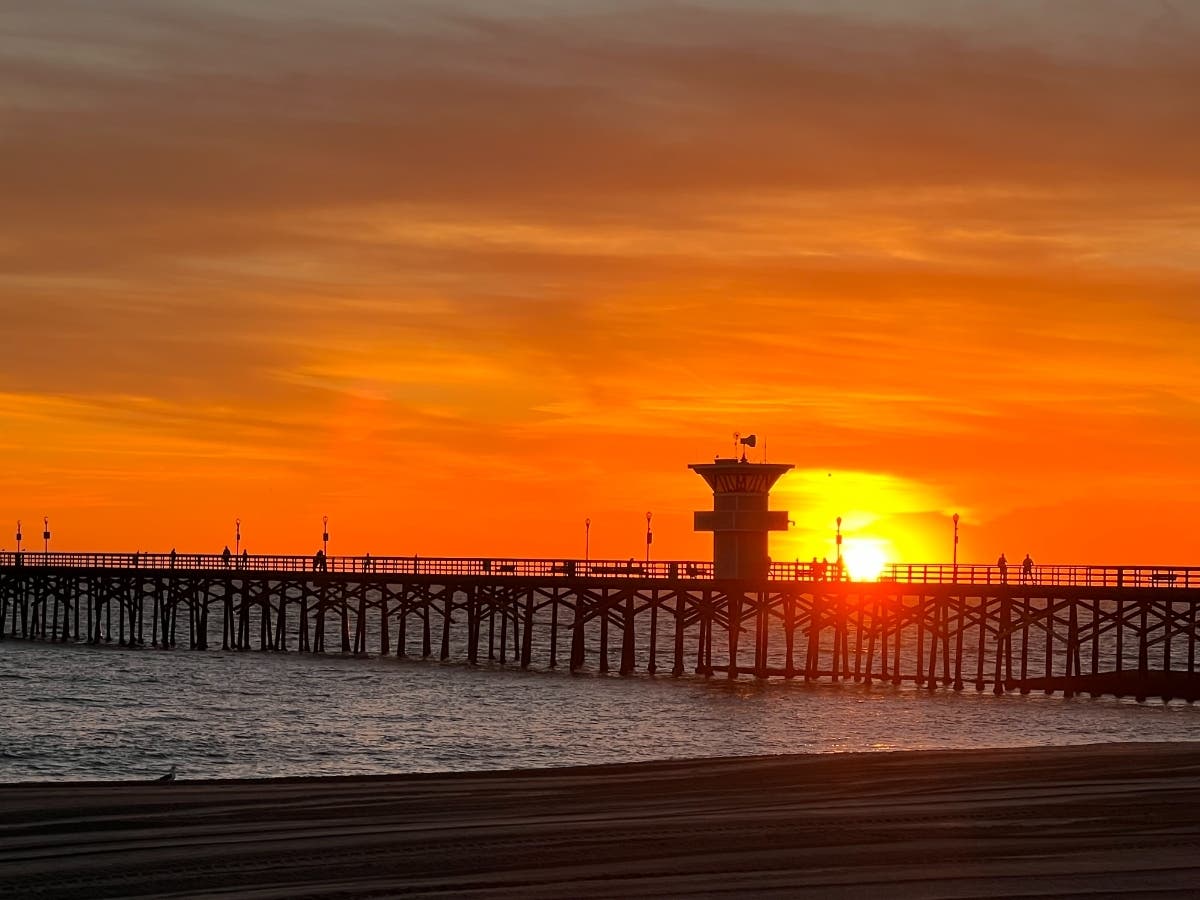 The sun sets over the Seal Beach Pier.