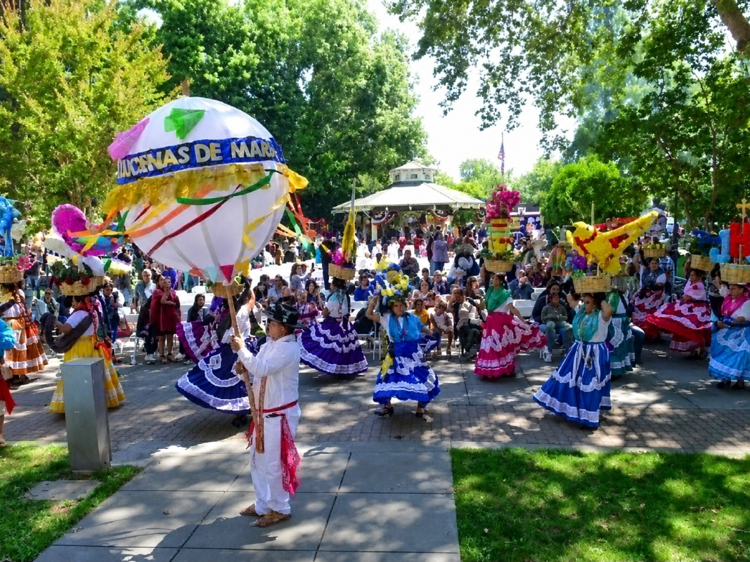 Performers parade through Healdsburg Plaza during a Guelaguetza festival, an annual celebration of Oaxacan culture featuring traditional music, dance, food, and artisan crafts. This year the Guelaguetza procession will parade to the Foley Pavilion.