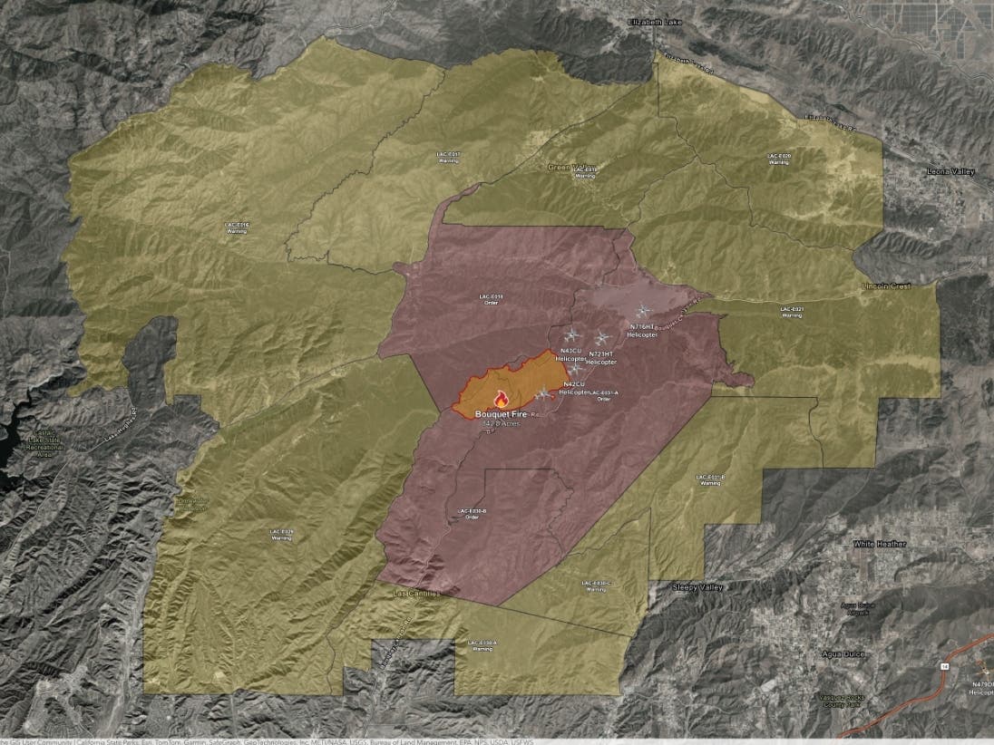 A wind shift was pushing the fire toward structures along Bouquet Canyon Road, prompting requests for structure protection, according to Watch Duty.