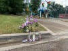 Flowers and candles placed near the site where a 16-year-old was slain Tuesday in Joliet.
