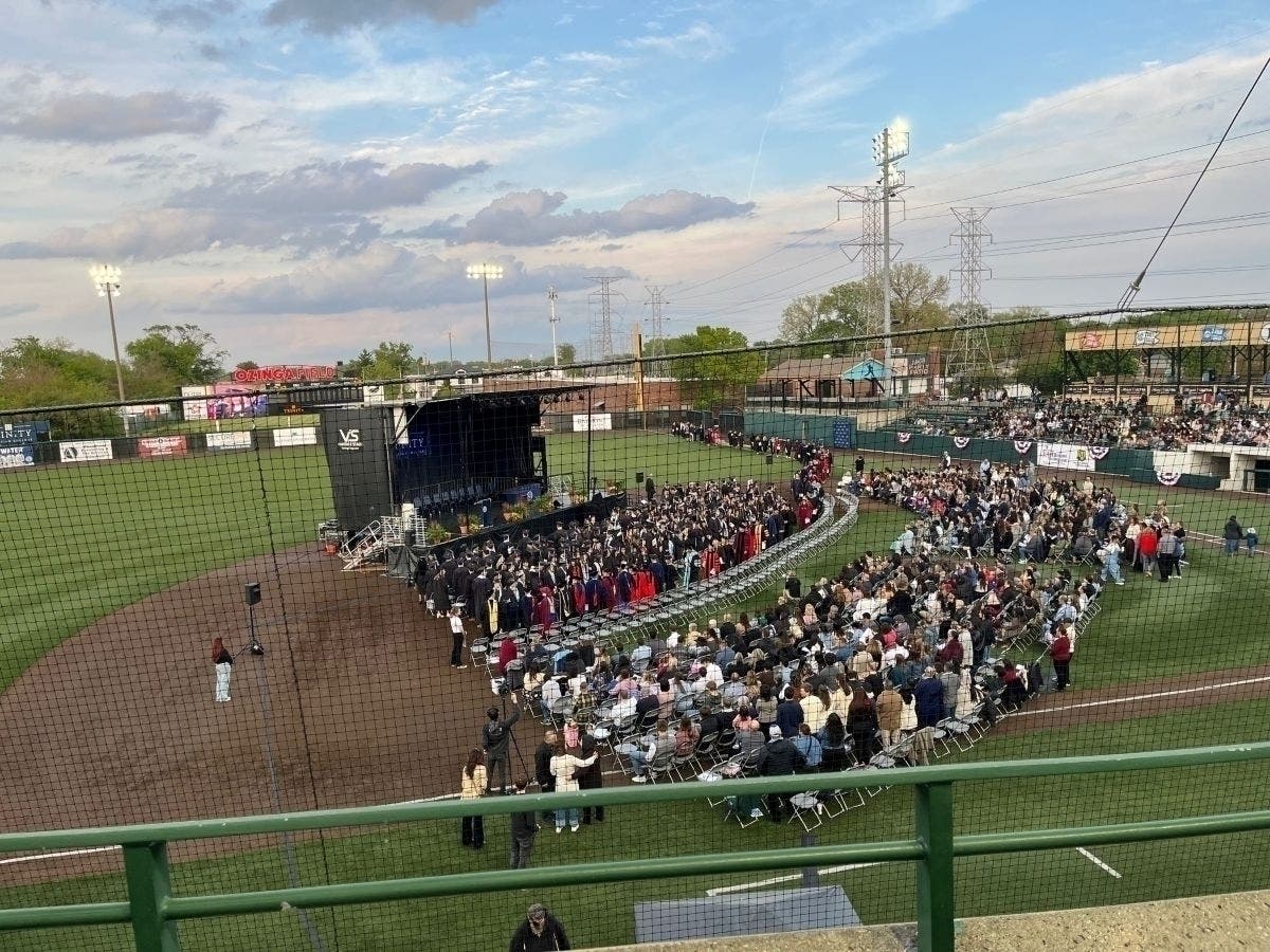 Trinity Christian College's last graduating class gathers for commencement exercises Friday at Ozinga Field in Crestwood. 