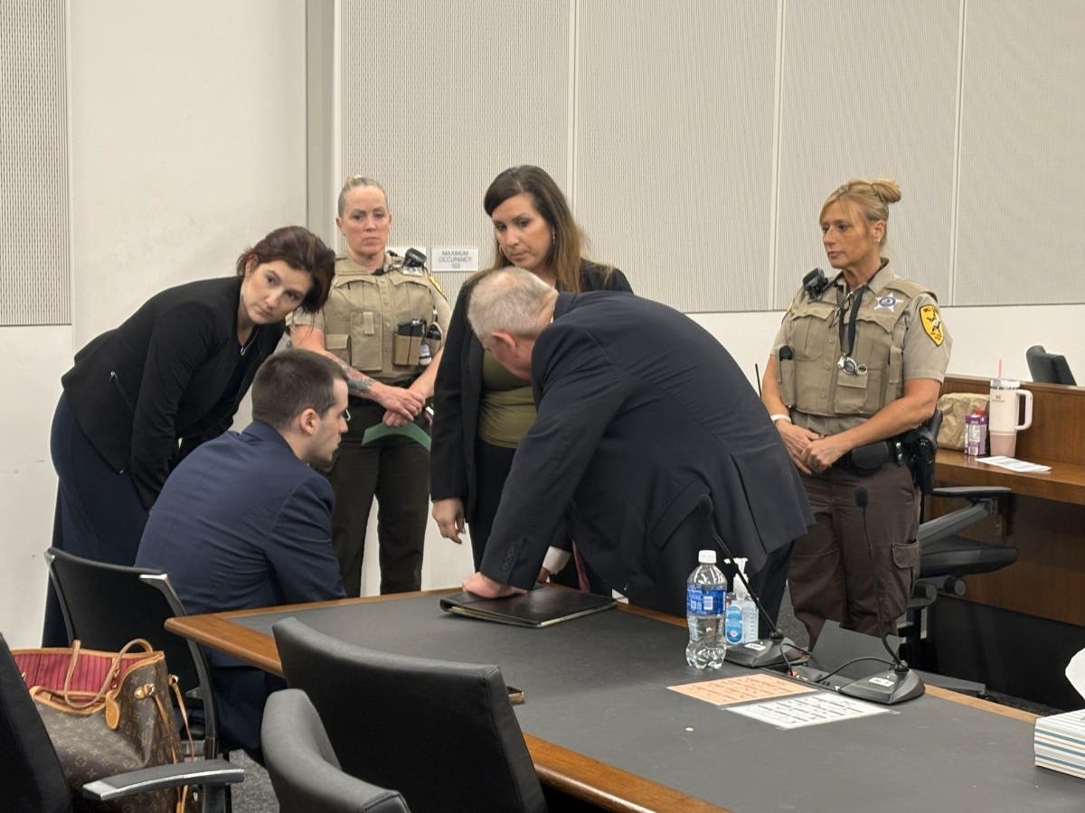 Attorneys and sheriff's deputies gather around Jon Hansen Friday after the guilty verdict was announced. Hansen self-identified as a Milwaukee Kings street gang member and was considered the treasurer, according to Facebook threads uncovered by police.