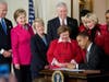 Obama signing the Lilly Ledbetter Fair Pay Act in to Law