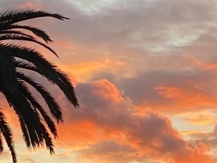 An orange sunset and sky full of clouds in Long Beach, Calif. 