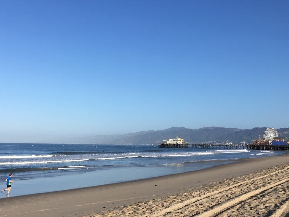 A runner jogs near Santa Monica Pier. 