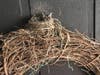 A bird's nest appears over a door. 
